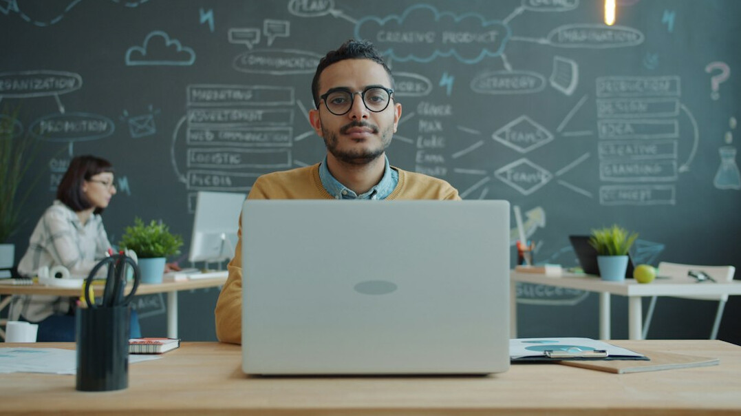 person using laptop at desk